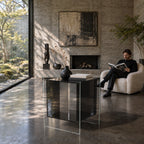 Cool Black Carter Side Table with a vase and books in a concrete living room