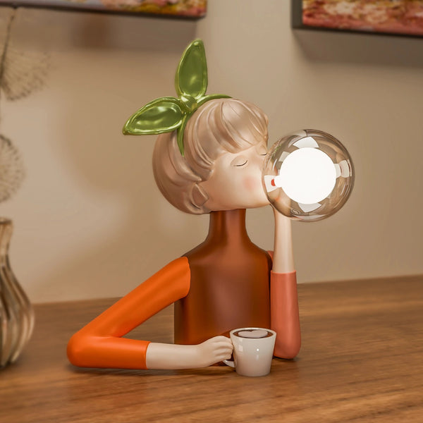 Ava bubble girl lamp with green bow holding a coffee cup, bubble globe lit