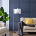 White faux feather shade on a gold arched floor lamp in daylight