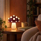 Small red mushroom lamp with white spots glowing in a reading nook