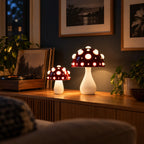 Two red mushroom lamps with white spots lighting a living room at night beside a record player