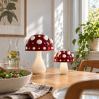 Two red mushroom lamps with white spots on a dining table at lunchtime